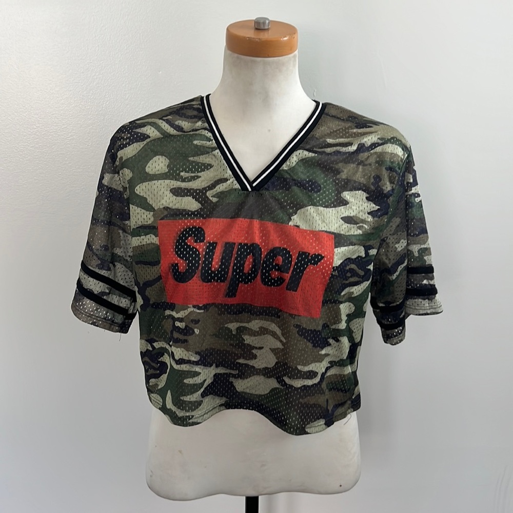 This is a women’s medium camo crop top with sheer holes.
